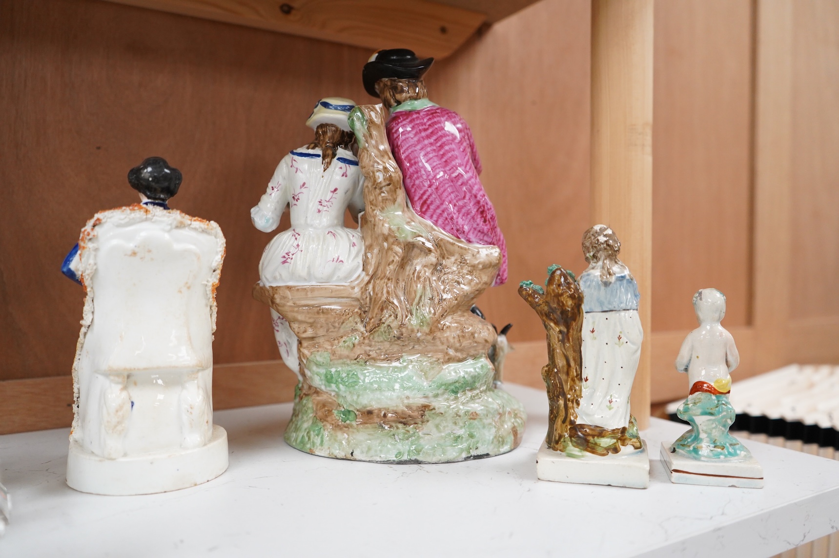A Ralph Wood style group and three Staffordshire figures, largest 26cm high